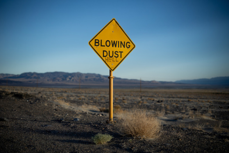 A sign warning of blowing dust has been vandalized near the small community of Keeler, which sits on the northwest side of the dry lakebed of Owens Lake in Inyo County, California, on Thursday, Aug. 11, 2022.