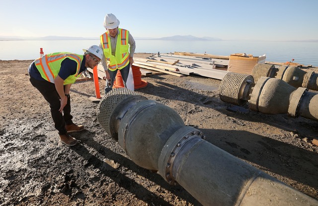 Dakota Ball, MWH Constructors Inc. manager, and Vivien L. Maisonneuve, program manager at the California Department of Water Resources' Salton Sea Management Program, inspect pipes that are used to pump water from the Salton Sea into ponds for the Species Conservation Habitat Project in Imperial County, Calif., on Wednesday, Dec. 13, 2023. The water will be mixed with water from the New River, enabling control over salinity concentrations in the habitat’s ponds.