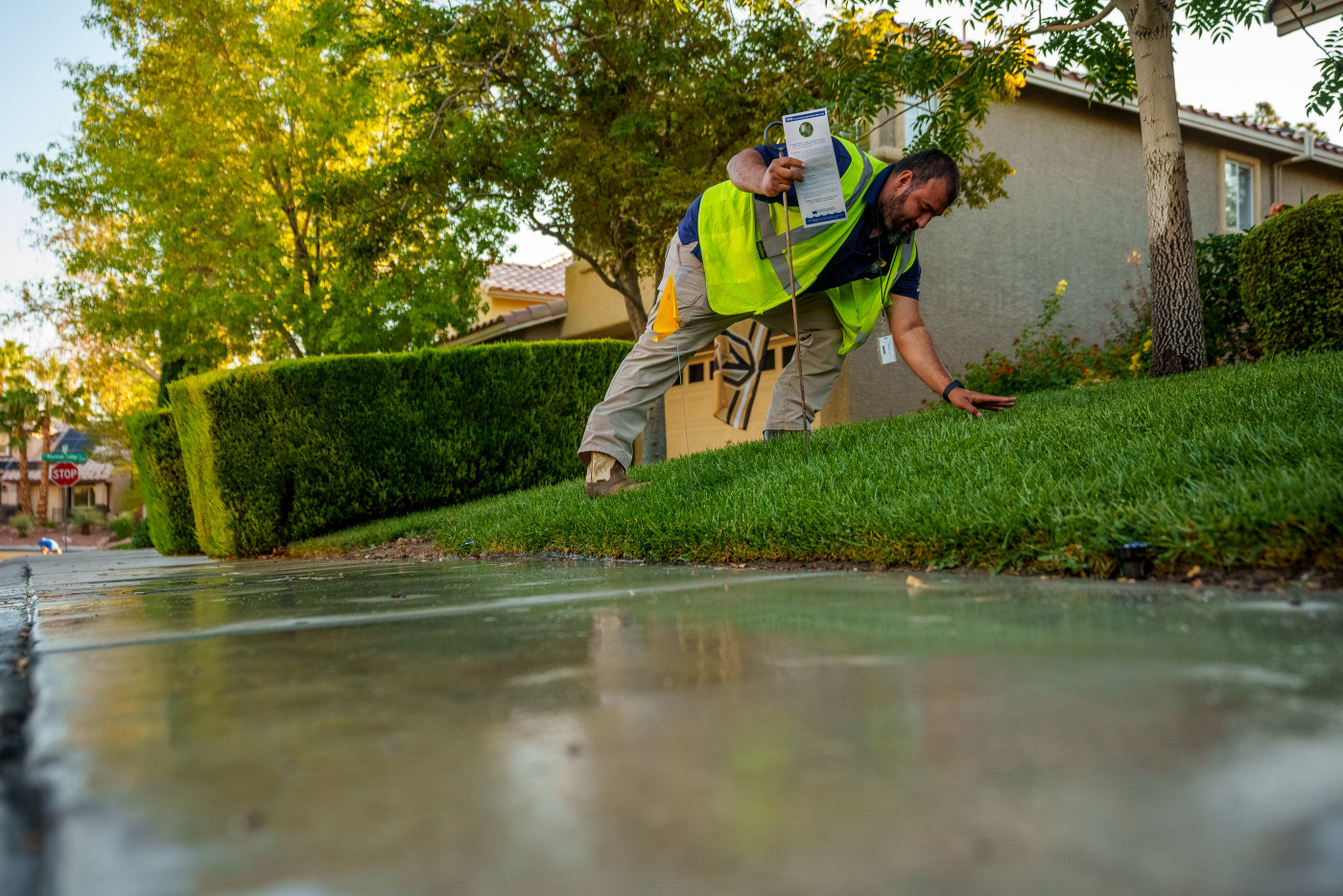 (Trent Nelson | The Salt Lake Tribune) Salvador Polanco-Gamez, a conservation aide with the Las Vegas Valley Water District, documents a leak in a sprinkler system in Summerlin, a community in the Las Vegas Valley, Nevada on Thursday, Sept. 29, 2022.