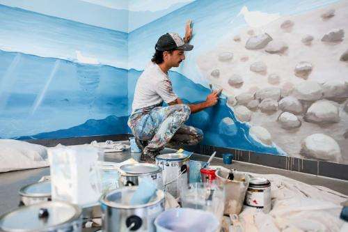 Argentinian artist Franco Cervata Cozza, who also goes by the artist name Vato, paints a mural at the George S. and Dolores Doré Eccles Wildlife Education Center in Farmington on Saturday. (Photo: Spenser Heaps, Deseret News)