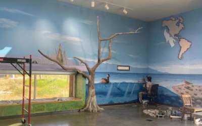 Ashley Kijowski / UDWR Franco "Vato" Cervato paints the Great Salt Lake mural at the Eccles Wildlife Education Center in Farmington Bay.