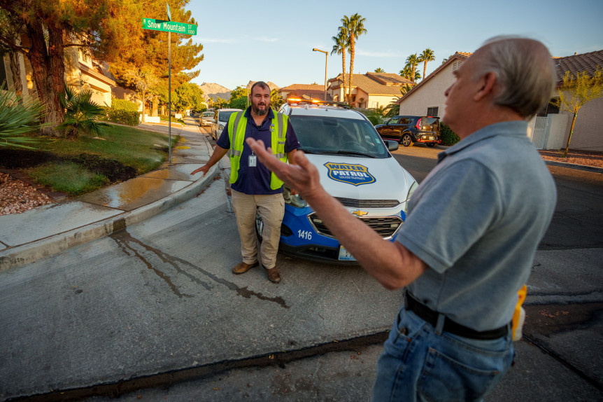 (Trent Nelson  |  The Salt Lake Tribune) Homeowner Guido Huizing, right, speaks with Salvador Polanco-Gamez, a conservation aide with the Las Vegas Valley Water District, on patrol in Summerlin, a community in the Las Vegas Valley, Nevada on Thursday, Sept. 29, 2022. When runoff water from a home's sprinklers reaches the street, Polanco-Gamez stops to document the situation and notify the homeowner.